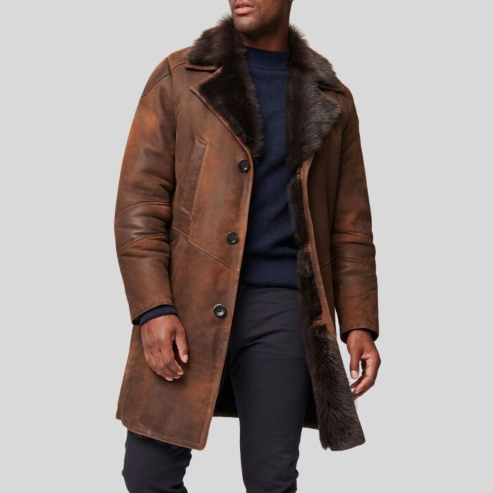Brown sheepskin leather trench coat with faux fur interior and button closure.